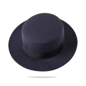 Detail view of deep purple wool felt fedora with black ribbon band on white background