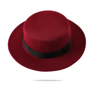 Classic burgundy flat-top boater hat with black ribbon and felt texture on white background