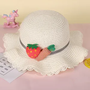 Detail of child straw hat with ruffle edge featuring 3D strawberry and carrot accents