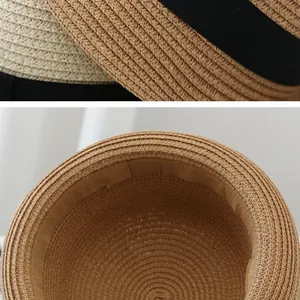 Detail of woven straw sun hat with black decorative ribbon and fine interior sweatband