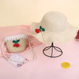 Straw sun hat and matching crossbody bag set with red cherry decor and wavy lace edges