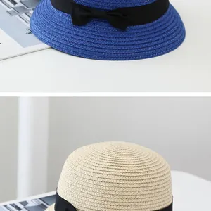 Close-up of woven sun hat texture with elegant black ribbon bow in blue and cream colors