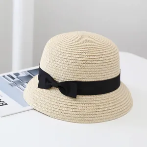 Elegant beige straw sun hat with black ribbon bow for women, stylish summer beach accessory