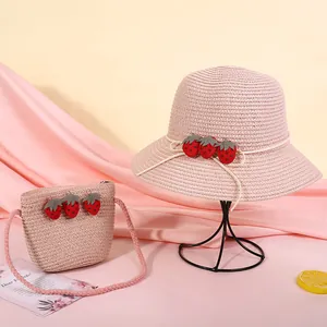 Detail von rosa Strohhut und Tasche mit drei dekorativen 3D-Erdbeeren für Kinder