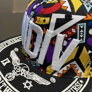 Close-up of 3D embroidery DIV text and street art graphics on a flat brim snapback cap