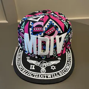 Close-up of MDIV 3D embroidery and colorful tribal patterns on a snapback baseball hat