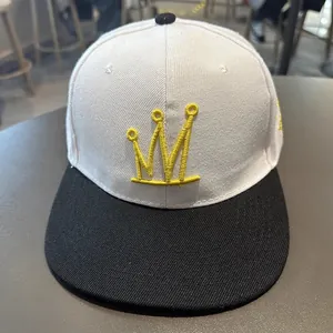 Détail de la casquette hip hop avec couronne jaune brodée sur une couronne en sergé
