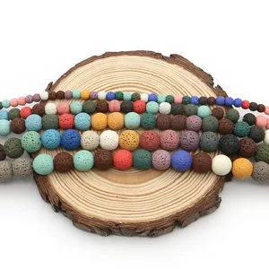Colorful natural volcanic rock lava beads in various sizes on a rustic wooden display