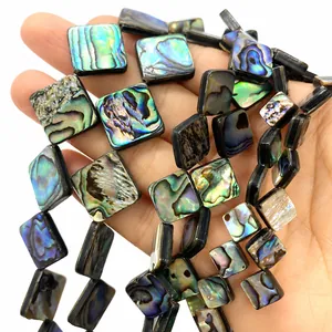 Macro shot of natural square abalone shell beads with vibrant iridescent rainbow luster