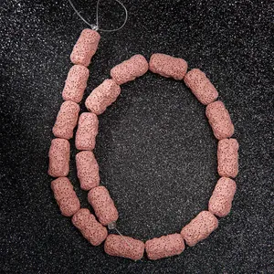 Makroaufnahme roter Lavastein-Zylinderperlen mit natürlicher poröser Textur für DIY