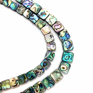 Macro detail of natural square abalone shell beads showing vibrant iridescent textures