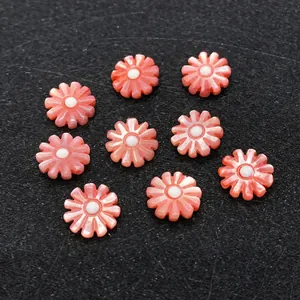 Detailed view of nine pink mother of pearl shell flower beads for DIY jewelry making