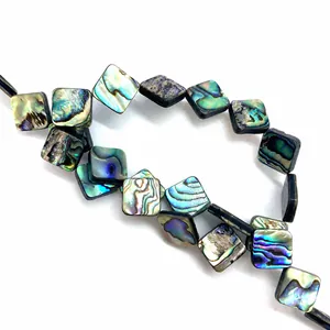 Macro shot of natural iridescent abalone shell square beads for DIY jewelry making