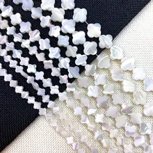 Detailed view of iridescent clover-shaped natural mother of pearl loose beads for DIY jewelry