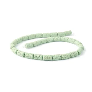 Macro shot of light green lava stone cylinder beads showing porous texture for DIY jewelry