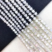 Macro view of natural star-shaped seashell loose beads with iridescent pearl luster
