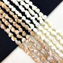 Macro detail of natural shell beads showing twisted texture and silky luster for DIY jewelry