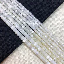 Macro view of natural iridescent white shell beads in various sizes for DIY jewelry making