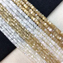 Macro shot of iridescent white and champagne shell beads for DIY jewelry making