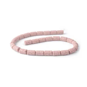 Macro detail of cylindrical pink volcanic stone beads with natural porous texture for DIY