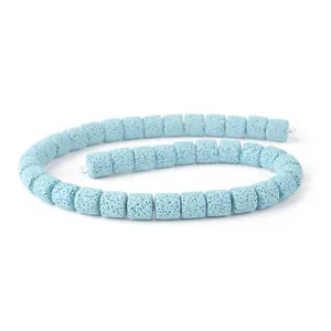Macro shot of light blue cylindrical lava stone beads with natural porous texture for DIY