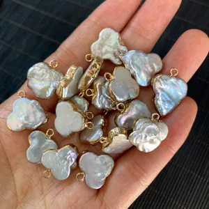 Macro detail of irregular cloud-shaped freshwater pearl pendant with gold plated metal edge