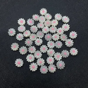 Macro shot of white daisy shell beads with pink centers for DIY jewelry making accessories