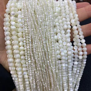 Macro detail of natural white mother of pearl round beads in various sizes for DIY jewelry