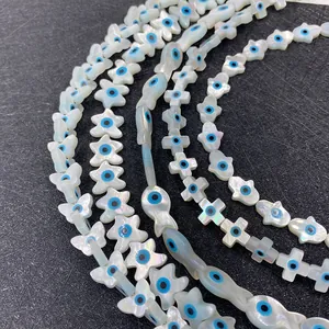 Natural white shell beads set with evil eye charms in butterfly and star shapes