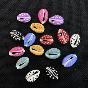 Macro view of colorful cowrie shell beads with hand-painted dots for DIY jewelry
