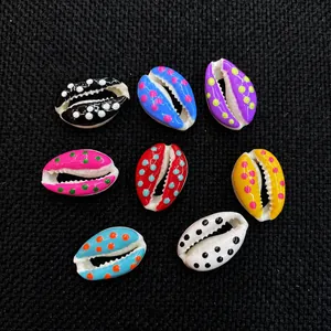 Close-up of colorful polka dot cowrie shells for DIY jewelry making in various vibrant colors