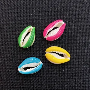 Detailed view of colorful shell-shaped beads in pink, yellow, green, and blue for DIY jewelry