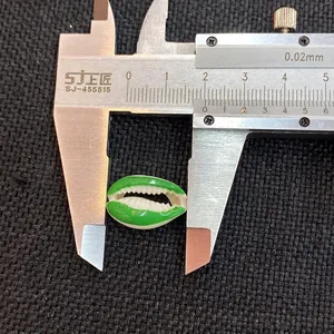 Macro view of a 1.8cm green and white seashell bead measured with a digital caliper