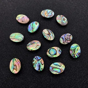 Macro detail of natural iridescent abalone shell oval beads for DIY jewelry making
