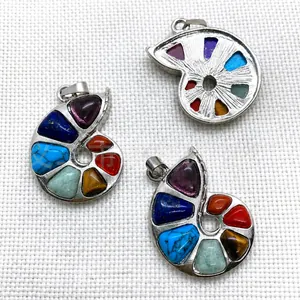 Detail of snail-shaped pendants with inlaid natural stones and silver metal bases