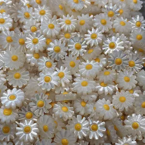 Macro shot of white shell daisy beads with iridescent petals for DIY jewelry making