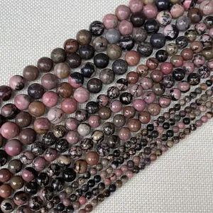 Perles en rhodonite naturelle polie de tailles variées avec motifs marbrés roses et noirs