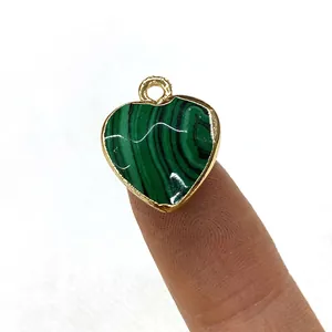 Faceted heart-shaped opal pendant with green malachite texture and golden metal edge