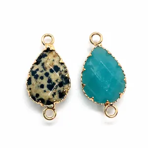 Detailed view of teardrop natural stone connectors with gold plating for jewelry making