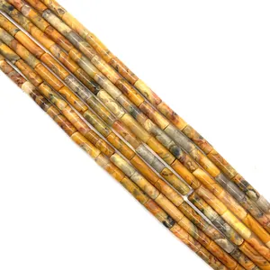 Macro view of cylindrical natural stone beads in orange and gray hues for DIY jewelry