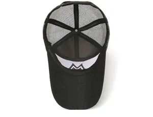 Detail of black trucker hat showing breathable mesh and internal M logo embroidery