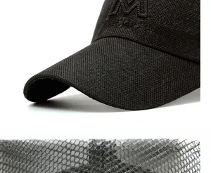 Detail of breathable mesh fabric and reinforced long brim on a black baseball cap