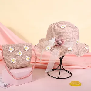 Set coordinato di cappello e borsa in paglia rosa con decorazioni di margherite bianche