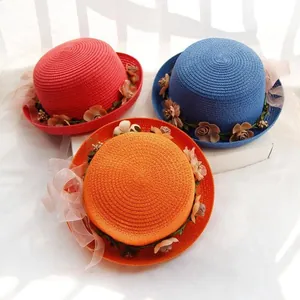 Detailed weave pattern of straw sun hats with 3D fabric flowers and lace bows