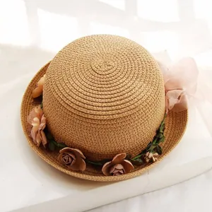 Women's summer straw sun hat with floral rose trim and pink bow for beach travel