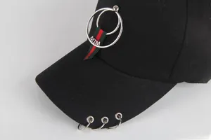 Close-up of black cotton baseball cap with silver metal rings and striped ribbon detail
