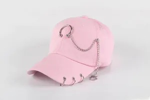 Detail of pink canvas baseball cap with silver metal rings and detachable chain link