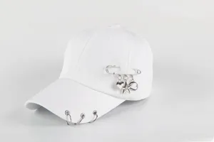 Detail of white cotton baseball cap with silver metal rings and star pin charms