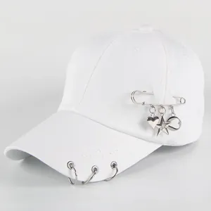 Minimalist white cotton baseball cap with silver metal rings and hanging heart charms