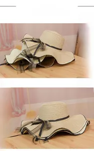 Detail of wide brim straw sun hat with polka dot ribbon and mesh bow in cream color